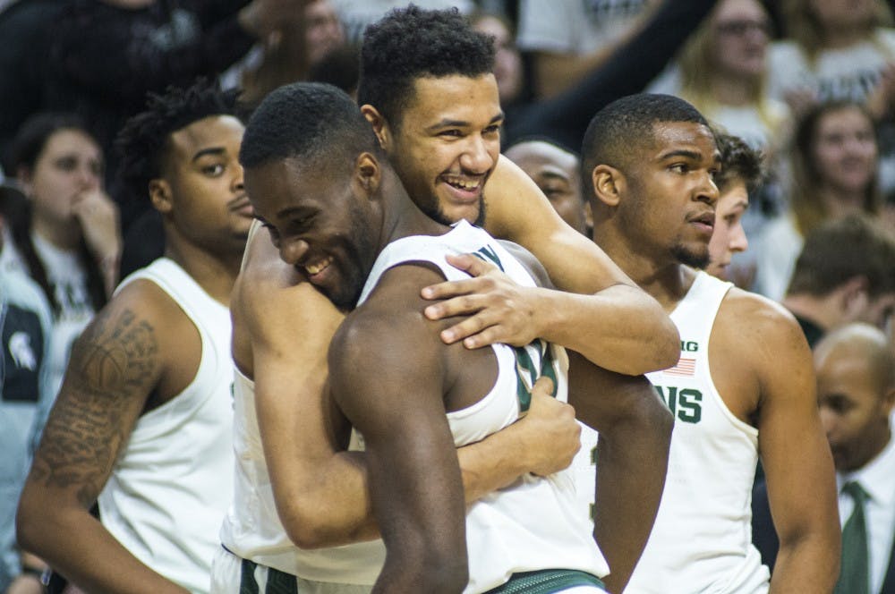Sophomore forward Kenny Goins (25) embraces junior guard Greg Roy (40) during the second half of the men's basketball game against Youngstown State on Dec. 6, 2016 at Breslin Center. The Spartans defeated the Penguins, 77-57.