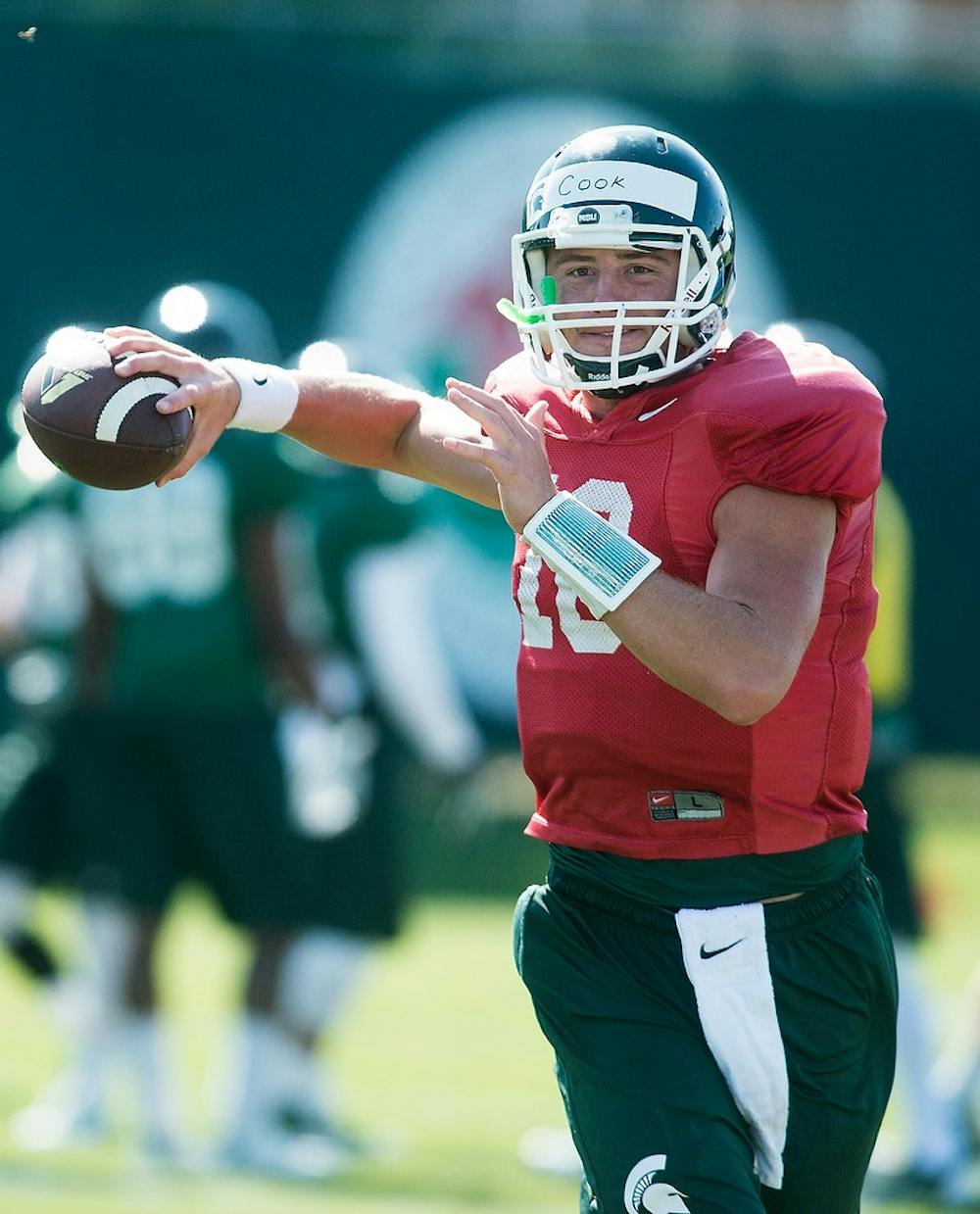 <p>Junior quarterback Connor Cook looks to throw the ball during practice on Aug. 14, 2014, at the practice field outside of Duffy Daugherty Football Building. The season kicks off Aug. 29, with a game against Jacksonville State. Danyelle Morrow/The State News</p>