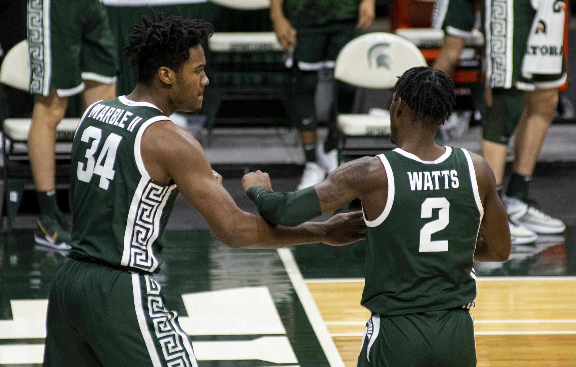 Sophomore forward Julius Marble (34) talks with teammate Rocket Watts (2) as they head into a timeout in the second half. The Spartans came back after the first half to pull out a 109-91 win on Dec. 13, 2020.
