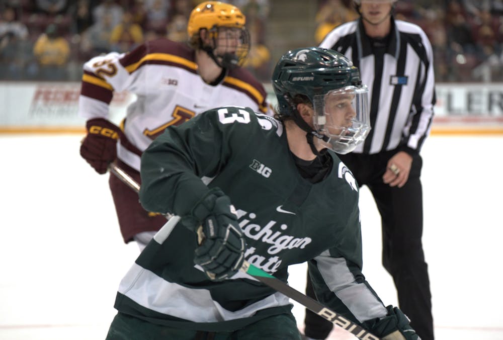 Freshman forward Tiernan Shoudy (13) heads toward the puck at 3M Arena at Mariucci on March 11, 2023. Michigan State fell 5-1 to Minnesota in the Big Ten Tournament semifinals.