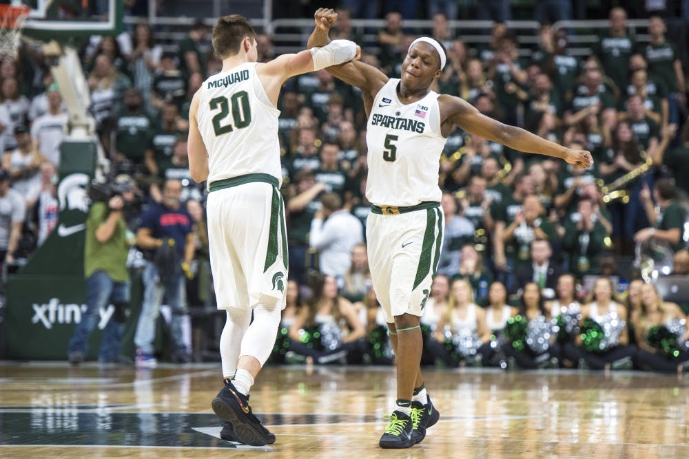 Junior guard Matt McQuaid (20) and sophomore guard Cassius Winston (5) link arms during the second half of the men's basketball game against Purdue on Feb. 10, 2018 at Breslin Center. The Spartans defeated the Boilermakers, 68-65. (Nic Antaya | The State News)