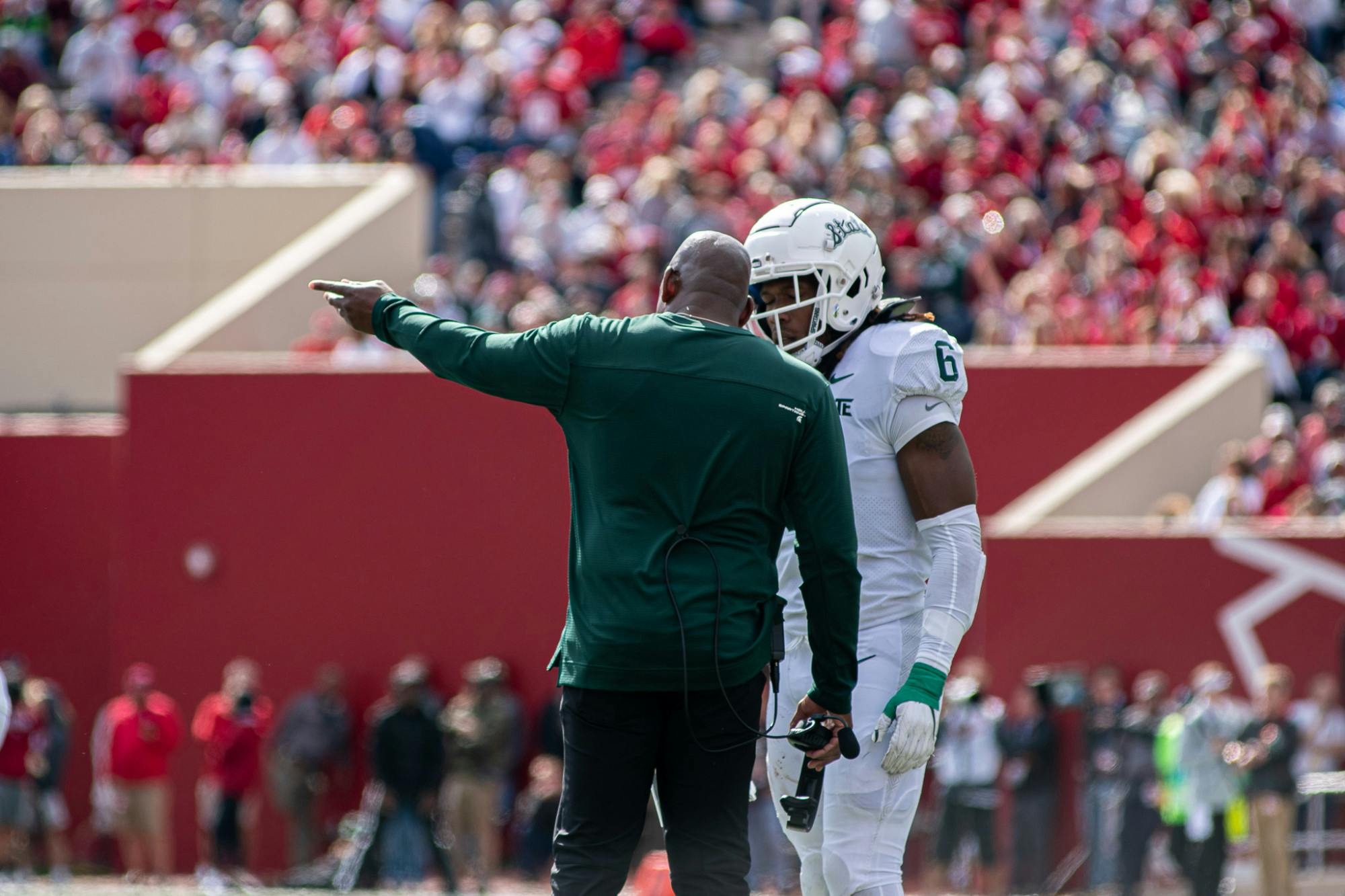 <p>Head Coach Mel Tucker talks to junior linebacker Quavaris Crouch. The Spartans found a way to hold on against the Hoosiers with a 20-15 win, scraping to their first 7-0 start since 2015 on Oct. 16, 2021.</p>