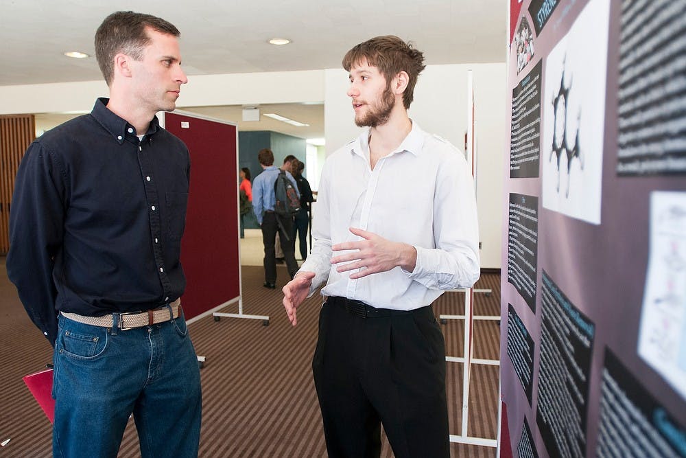 	<p>Vladislav Jdanov, right, a freshman in the Lyman Briggs College, talks to chemistry associate professor Ryan Sweeder about styrene April 22, 2013, during the Lyman Briggs College Research Symposium. Styrene is a synthetic chemical used in the manufacture of plastics, rubber and resins. </p>