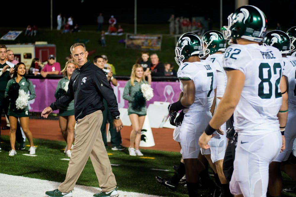 Head coach Mark Dantonio leads the Spartans out to the field before the game against Indiana on Oct. 1, 2016 at Memorial Stadium in Bloomington, Ind. The Spartans were defeated by the Hoosiers in overtime, 24-21.