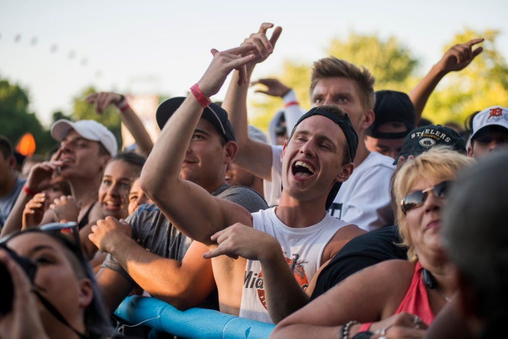 East Lansing resident Derek Coleson dances to the performance of French Montana during Common Ground Music Festival on July 8, 2016 at Adado Riverfront Park in Lansing, Mich.