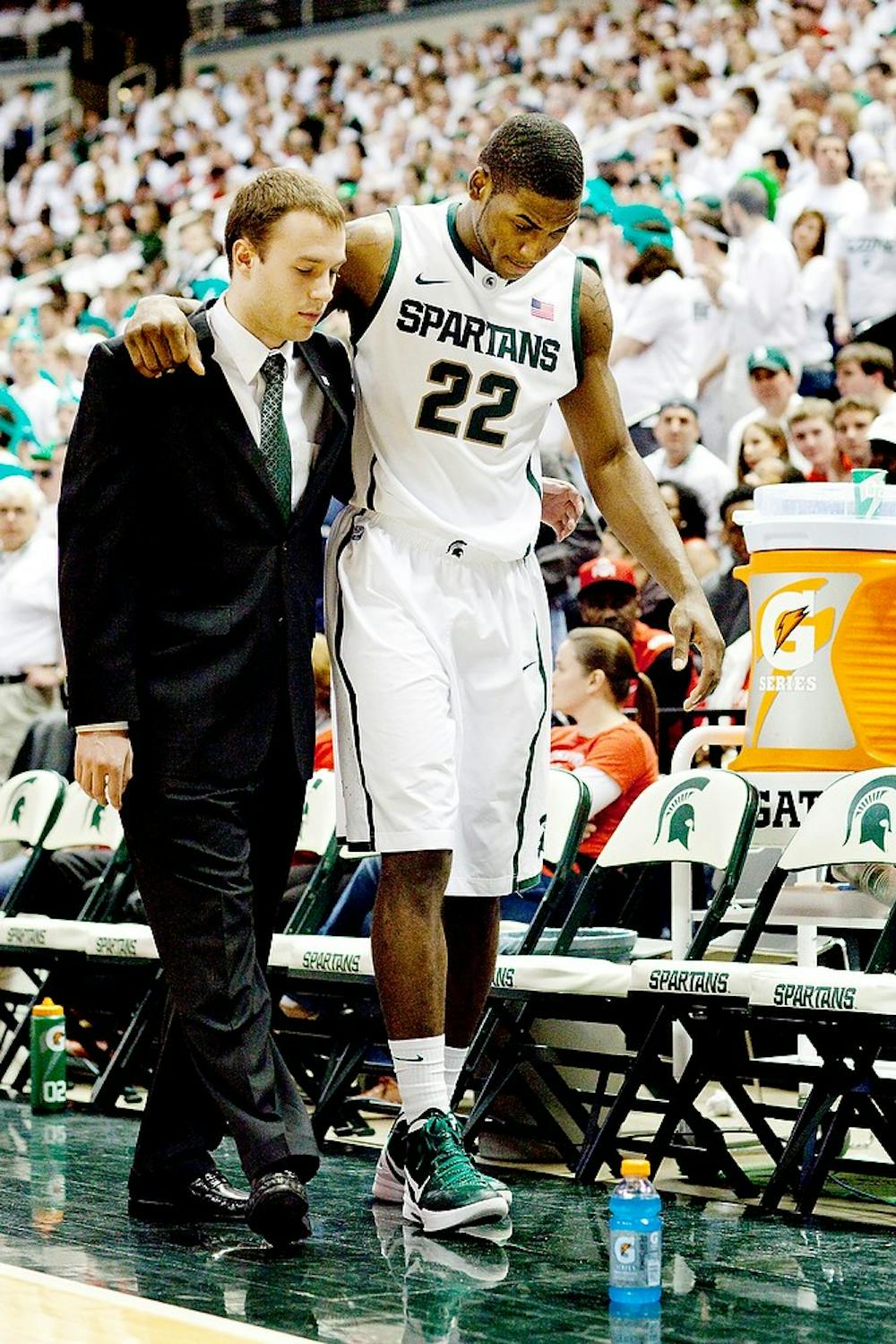 Then-freshman guard Branden Dawson is helped off of the floor after tearing his anterior cruciate ligament Sunday, March 4 at Breslin Center. Dawson will be forced to sit out from the NCAA tournament due to the injury. State News File Photo