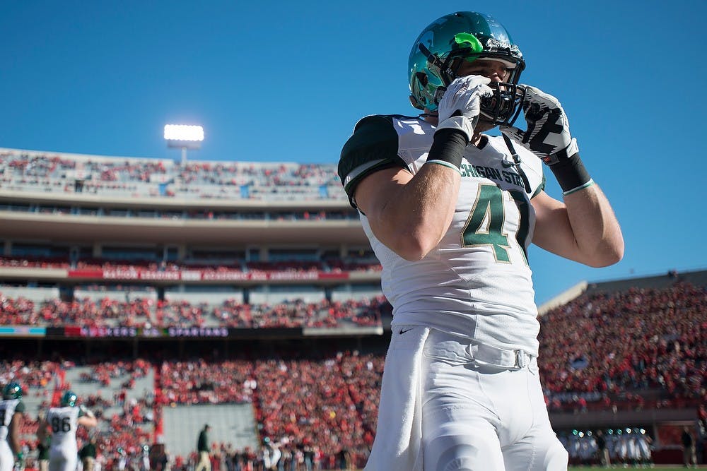 	<p>Senior linebacker Kyler Elsworth adjusts his helmet Nov. 16, 2013, at Memorial Stadium in Lincoln, Neb. before the game against Nebraska. The Spartans defeated the Cornhuskers, 41-28. Julia Nagy/The State News </p>