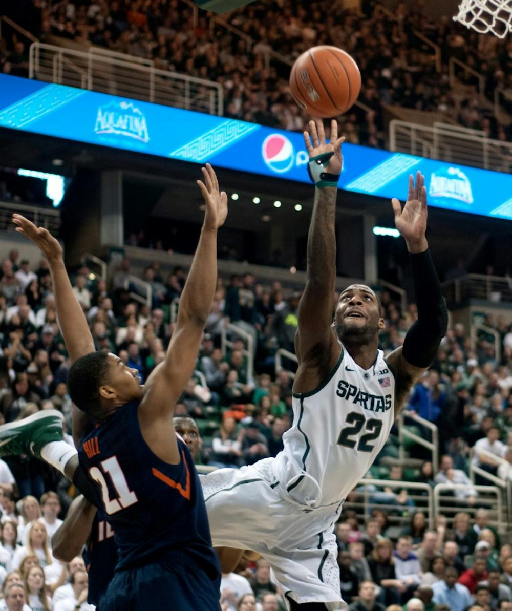 <p>Junior guard/forward Branden Dawson shoots while defended by Illinois guard Malcolm Hill on March 1, 2014, at Breslin Center. Illinois beat MSU, 53-46. Betsy Agosta/The State News</p>
