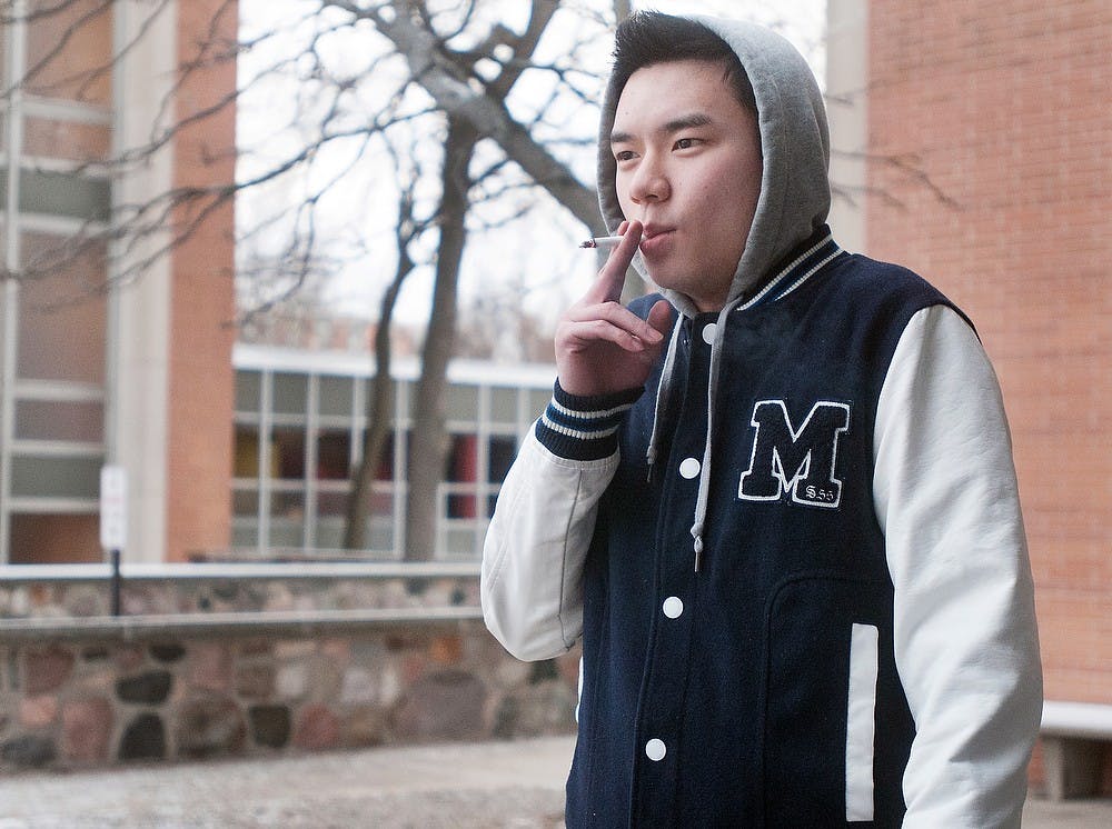 	<p>Supply chain management freshman Jeffrey Ching stands outside North Hubbard Hall to smoke Monday, Jan. 14, 2013. Ching said cigarettes in Michigan are much more expensive than those in China, which he equated to approximately $2. Danyelle Morrow/The State News</p>