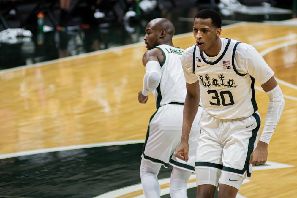Junior forward Marcus Bingham Jr. jogs back after sinking two free throws in the final minutes of the Spartans' win against Penn State on Feb. 9, 2021.
