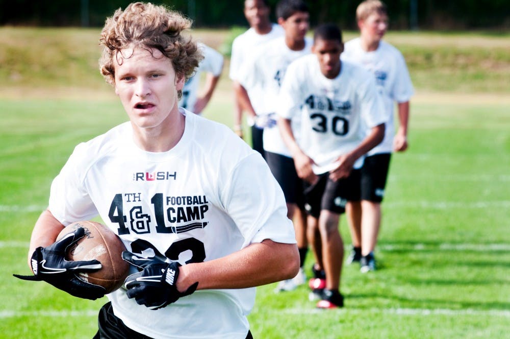 	<p>Three Rivers resident Kyle Walczak, 15, participates in a catching drill as part of the 4th and 1 football camp Tuesday morning at Lansing Catholic Central High School. The camp is hosted by former Spartan football player Kaleb Thornhill and is designed to improve both football and test taking skills for at-risk high school students.</p>