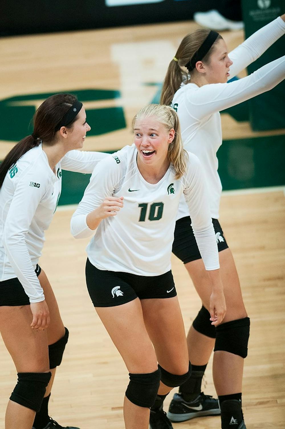 	<p>Senior middle blocker Kelsey Kuipers laughs with teammates between serves during the Green and White match, Aug. 24, 2013, at Jenison Field House. The White Team won, 2-1. Danyelle Morrow/The State News</p>