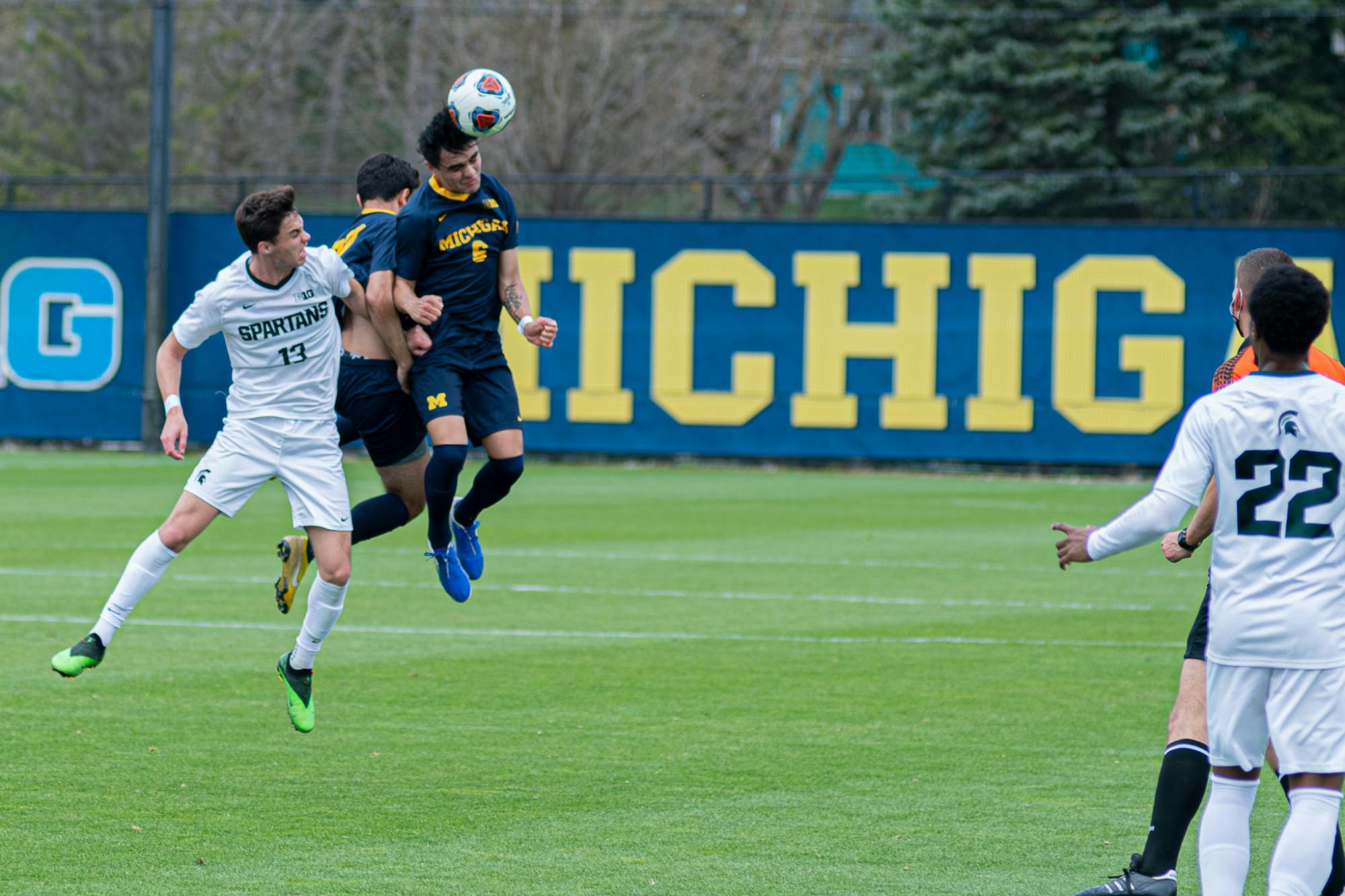 <p>Freshman midfielder Quin Rodgers (6) heads the ball on April 10, 2021, during the Wolverines&#x27; 1-0 victory against the Spartans.</p>