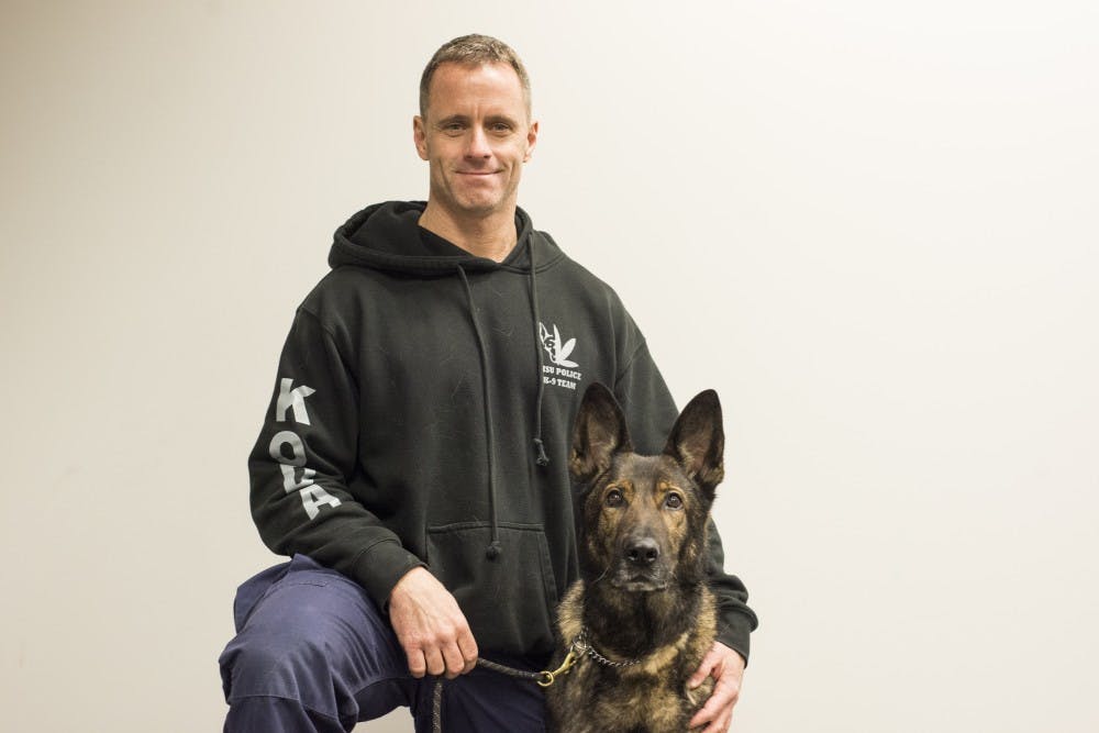MSUPD officer Mike Cantrell poses for a portrait with his K-9, Koda, on Feb. 8, 2017 at the East Lansing Police Department K-9 training facility in Lansing, Mich. Koda is a dual purpose dog and he specializes in narcotics and patrol work.