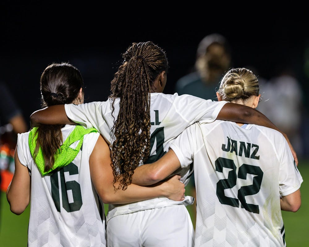 <p>Michigan State women's soccer players Jr. M, Kaleigh McPherson (16, left), Sr. F, Kennedy Bell (24, middle), and Sr. M, Ella Janz (22, right), embrace each other as they walk to the bench after a game againdt Xavier University in DeMartin Stadium in East Lansing, Mich., on Aug. 12, 2026.</p>