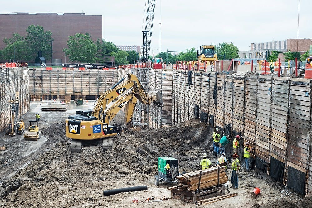 <p>Workers assemble walls June 25, 2014, at the Facility for Rare Isotope Beams along Wilson Road and Bogue Street. The work site is 40 feet deep. The Facility for Rare Isotope Beams will enable scientists to better understand rare isotopes, which can be used in the development of medical diagnostics. Corey Damocles/The State News</p>