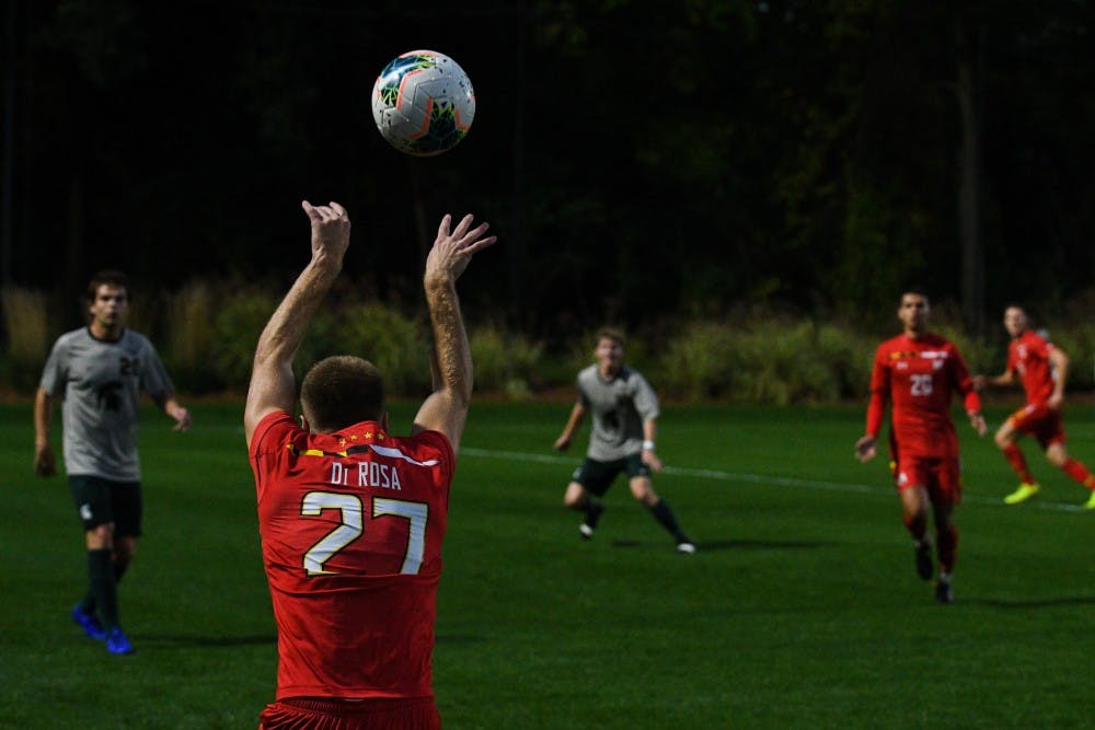 <p>Maryland junior midfielder Matt Di Rosa (27) makes a throw-in during the game against Maryland at DeMartin Stadium on October 11, 2019. The Spartans tied the Terrapins 1-1.</p>
