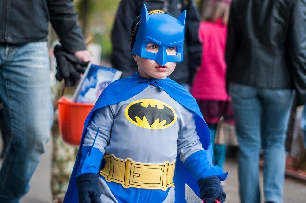 	<p>East Lansing resident Alex Skrotzi, 3, goes trick-or-treating along Grand River Avenue on Oct. 24, 2013. Businesses along Grand River Avenue passed out candy to trick-or-treaters of all ages. Khoa Nguyen/The State News</p>