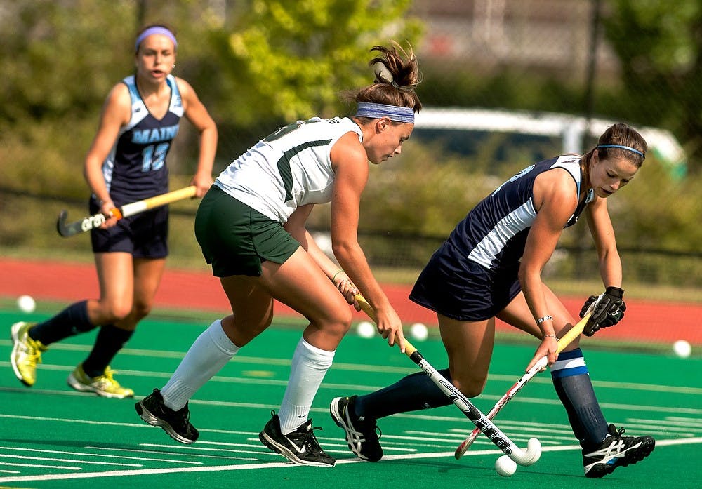 <p>Senior forward Abby Barker fights for the ball past Maine midfielder Becca Paradee during a game against the University of Maine Aug. 31, 2014, at Ralph Young Field. The Spartans defeated the Black Bears, 5-4 in overtime. Jessalyn Tamez/The State News </p>