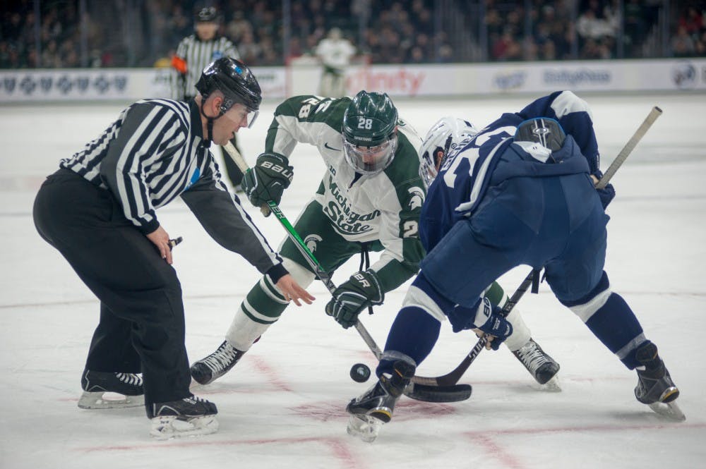 Penn state guard Matthew Skoff and junio forward Thomas Ebbing face off during the hockey game against Penn State on Feb. 13, 2016 at Munn Ice Arena. The Spartans were defeated in shootout by the Nittany Lion, 2-2.