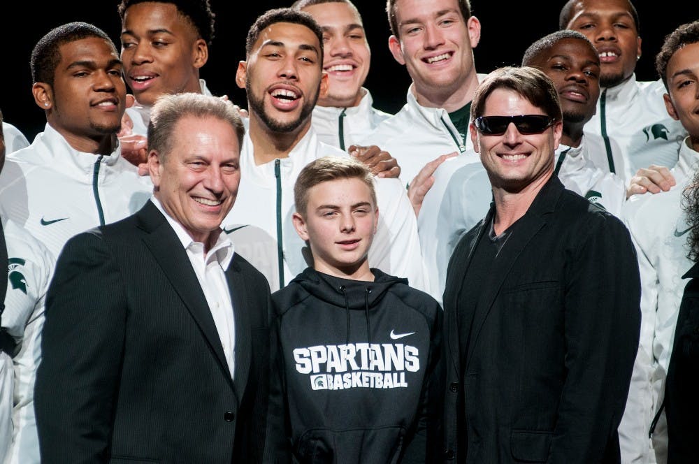 <p>The MSU mens basketball team, mens head coach Tom Izzo, Steven Izzo and a Tom Cruise impersonator pose for a picture on Oct. 23, 2015, at Breslin Center. Thousands of fans filled the Breslin Center to kick off the 2015-2016 basketball season. </p>