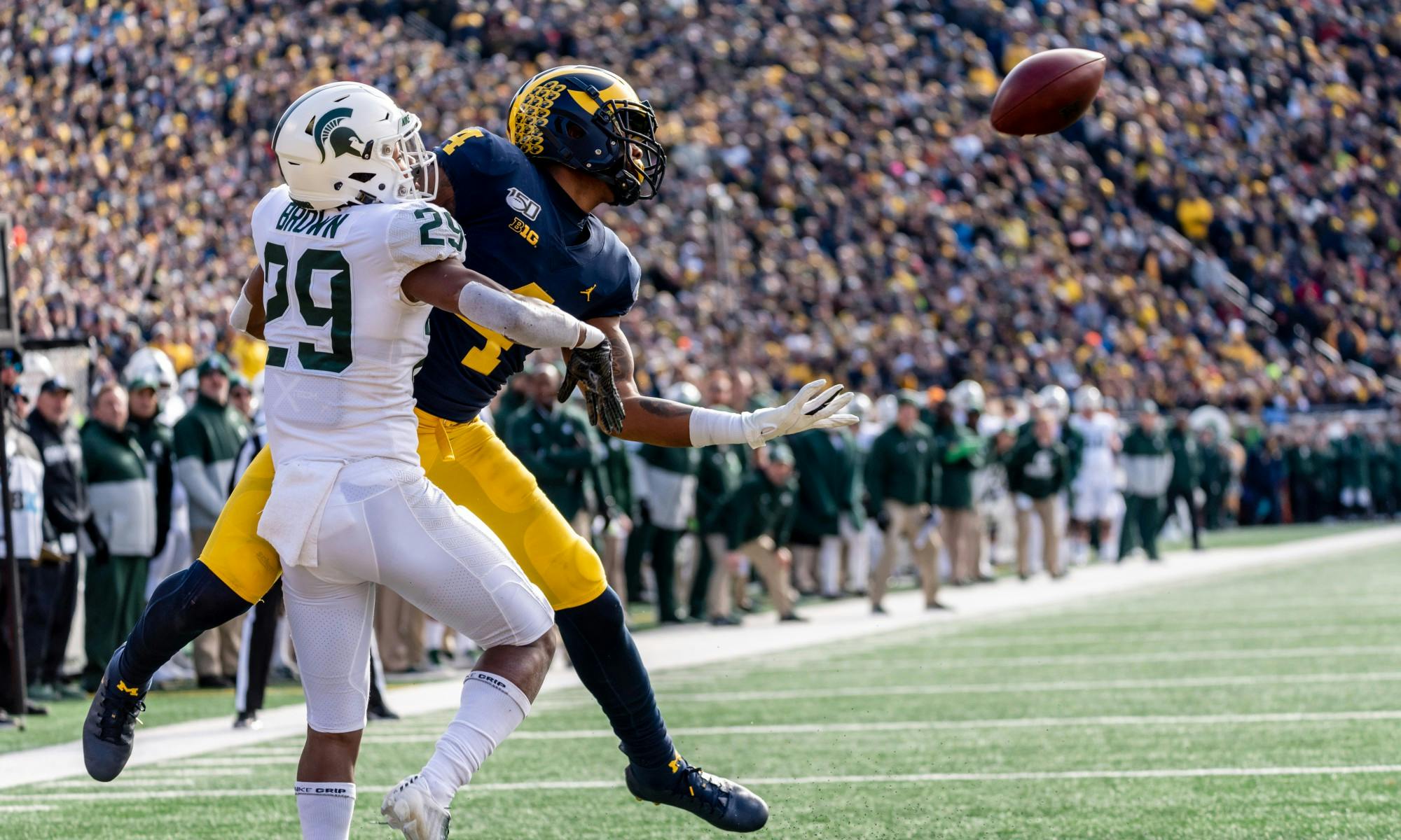 Sophomore cornerback Shakur Brown (29) interferes with Michigan wide receiver Nico Collins (4). 