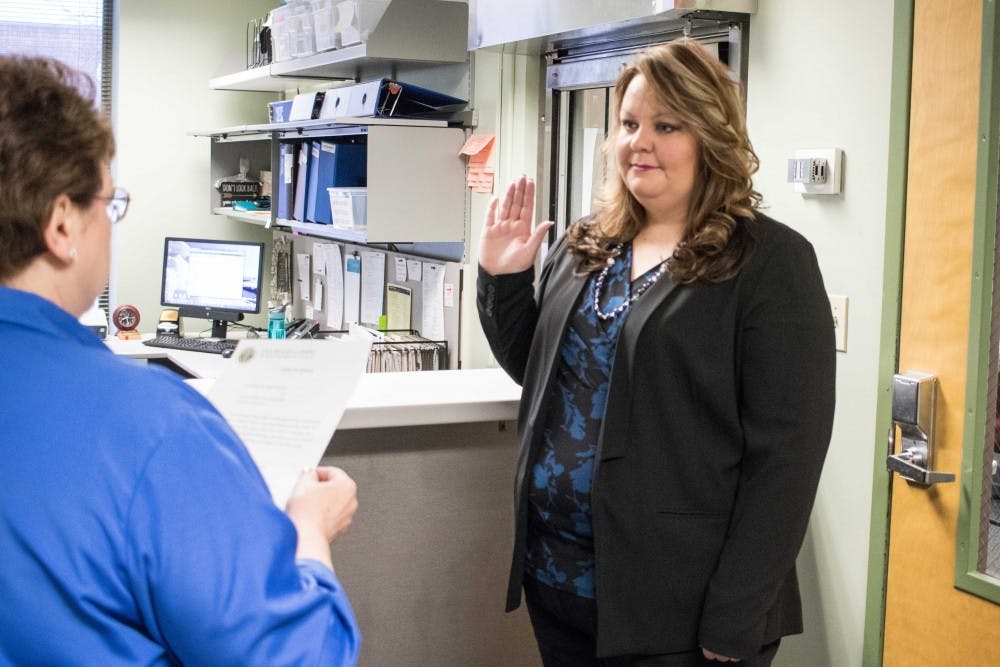 <p>Jennifer Shuster is sworn in as East Lansing City Clerk on Jan. 17, 2018, at the East Lansing City Hall.</p>