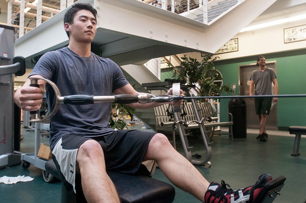 	<p>Finance sophomore Stephen Oh exercises his pectoral muscles in the fitness room of IM West on Monday, Jan. 28, 2013. The fitness center fee is proposed to be included in a student&#8217;s annual tuition bill, allowing students free access to the center. Danyelle Morrow/The State News</p>