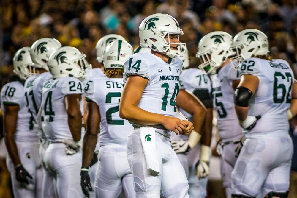 <p>Sophomore quarterback Bryan Lewerke (14) listens for a play call during the game against Michigan on Oct. 7, 2017 at Michigan Stadium. The Spartans defeated the Wolverines, 14-10.</p>