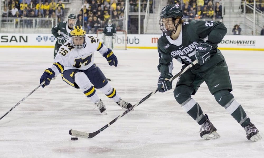 <p>Sophomore forward Mason Appleton (27) takes the puck up the rink as University of&nbsp;Michigan forward Max Shuart (25) tries to take possession of the puck during the third period of the men’s hockey game against the University of Michigan on Feb. 11, 2017 at Yost Ice Arena in Ann Arbor. The Spartans defeated the Wolverines, 4-1.</p>