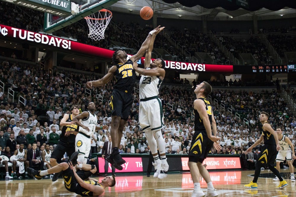 Iowa forward Tyler Cook (25) blocks a shot by sophomore forward Xavier Tillman (23) during the game against Iowa University at Breslin Center on Dec. 3, 2018. The Spartans defeated the Hawkeyes, 90-68.
