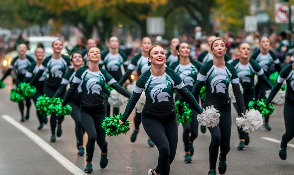 The MSU Pom team performs during the MSU Homecoming Parade on Oct. 5, 2018 along Grand River.