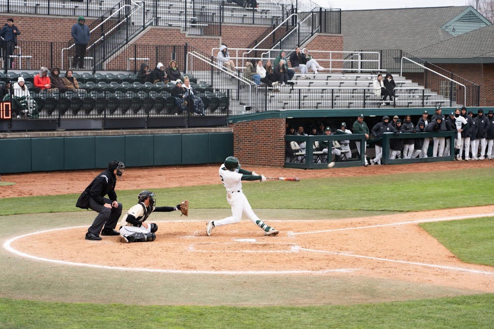 <p>Third baseman Dillan Kark gets himself a base hit at McLane Baseball Stadium in East Lansing on Wednesday, March 27, 2024. Kark went 2-5 during MSU's 7-11 loss to the Oakland Golden Grizzlies.</p>
