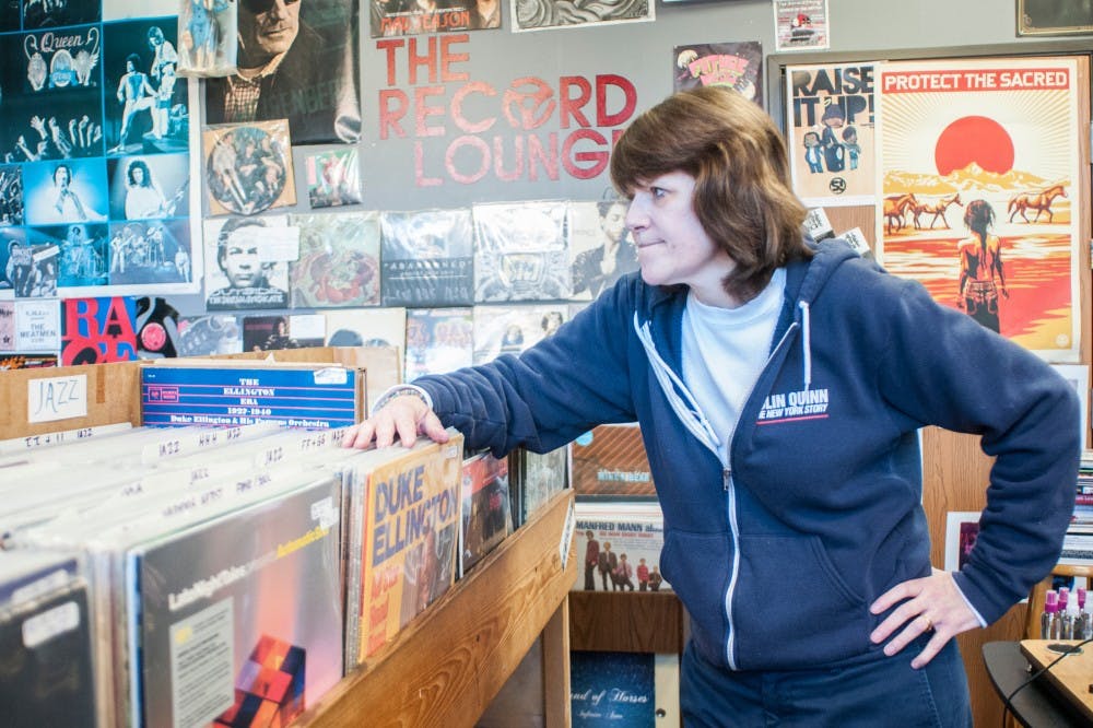 DeWitt resident Heather Frarey looks at her store The Record Lounge on March 28, 2017 at 111 Division Street. Frarey has owned the shop, which is now closing, for 9 years. "It is what is is... sometimes things happen for a reason," Frarey said. 