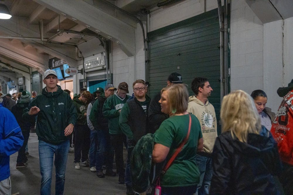Spectators pack into winding concession lines at Spartan Stadium in East Lansing, Mich., on Saturday, Nov. 16, 2025, leading to extended waits during the game.
