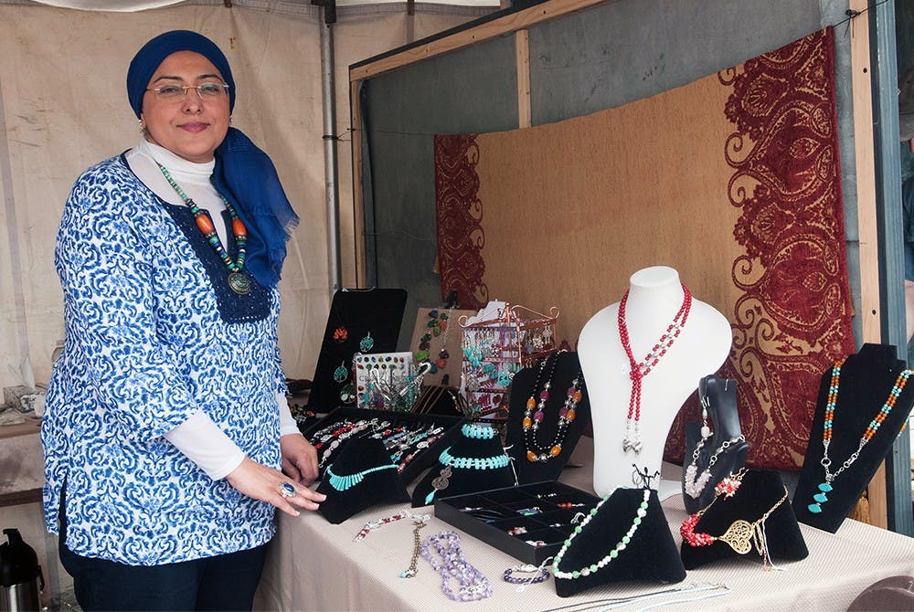 <p>Naglaa Seoudy awaits customers who view and buy her handmade jewelry May 17, 2015 at the East Lansing Art Festival. Seoudy discovered her love for making jewelry when she would take apart her own necklaces just to put them right back together. Asha Johnson/The State News</p>