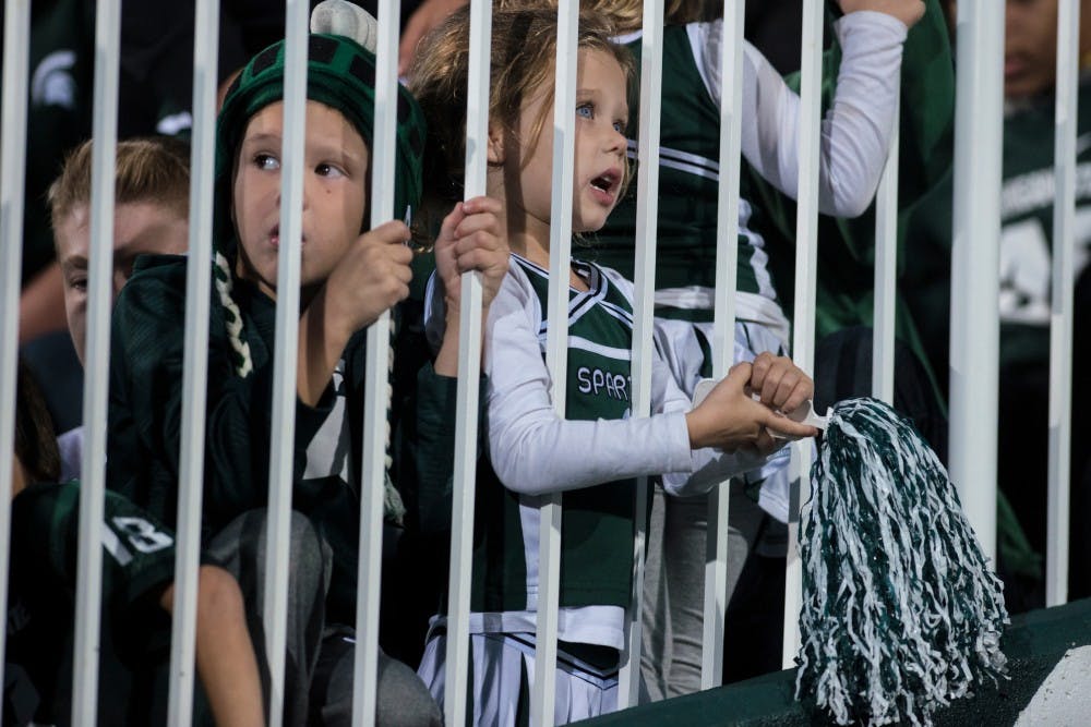 Beverly Hills, Mich. residents Jack Drikert, 5, left, and Lucy Drikert , 7, watch the fourth quarter of the game against Northwestern on Oct. 15, 2016 at Spartan Stadium. The Spartans were defeated by the Wildcats, 54-40.