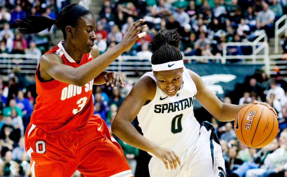 Freshman guard Kiana Johnson looks charges Ohio State guard Amber Stoke Sunday evening at Breslin Center. Johnson made two of nine field goals in the 56-64 defeat by Ohio State. Matt Hallowell/The State News