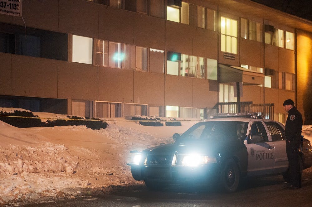 	<p>East Lansing police officers stand in front of apartment complexes on the 200 block of Cedar street, Jan. 31, 2014.  Danyelle Morrow/The State News</p>