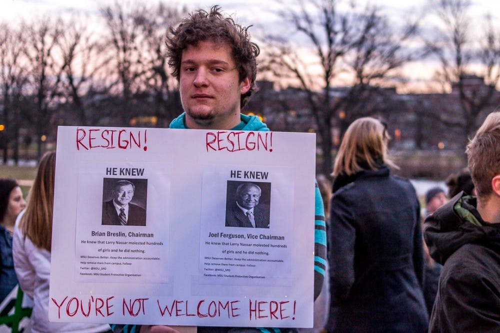 Political science freshman Aaron Mariasy holds his sign on Jan. 26, 2018 at The Rock. “It’s 20 years of indifference and complacency that’s allowed this to happen,” said Mariasy.  The peaceful protest was organized by students in support of sexual assault survivors and demanding change from Michigan State University in the wake of the Nassar abuse scandal.  

