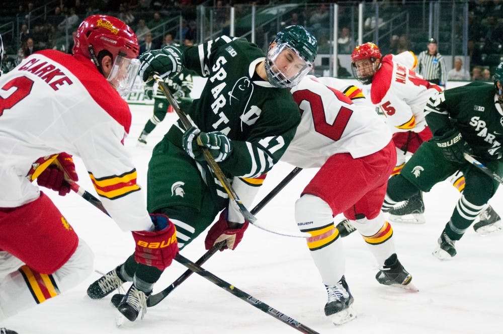 Freshman forward Taro Hirose (17) dodges two Ferris State defensemen during the game against Ferris State on Nov. 11, 2016 at Munn Ice Arena. The spartans were defeated by the bulldogs, x-x. 