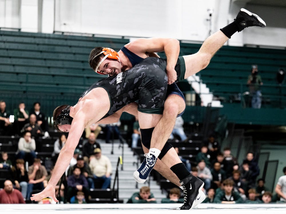 <p>Illinois’ Dylan Connell (197) lifts and returns Michigan State’s Kael Wisler (197) to the mat during their bout as the Spartans fall to the Fighting Illini at the Jenison Field House on Friday Jan. 16, 2026.</p>