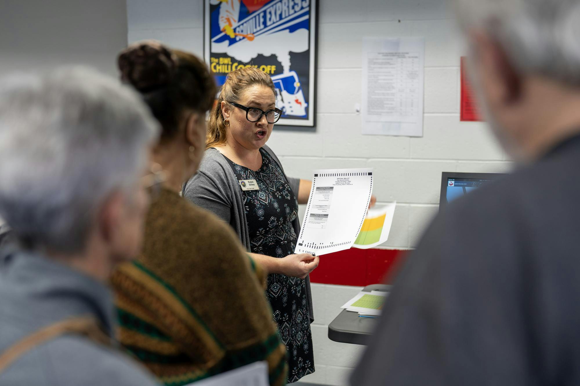 Lansing City Clerk's office employee Robin Stiles instructs election workers on early voting procedure on Oct. 26, 2023.