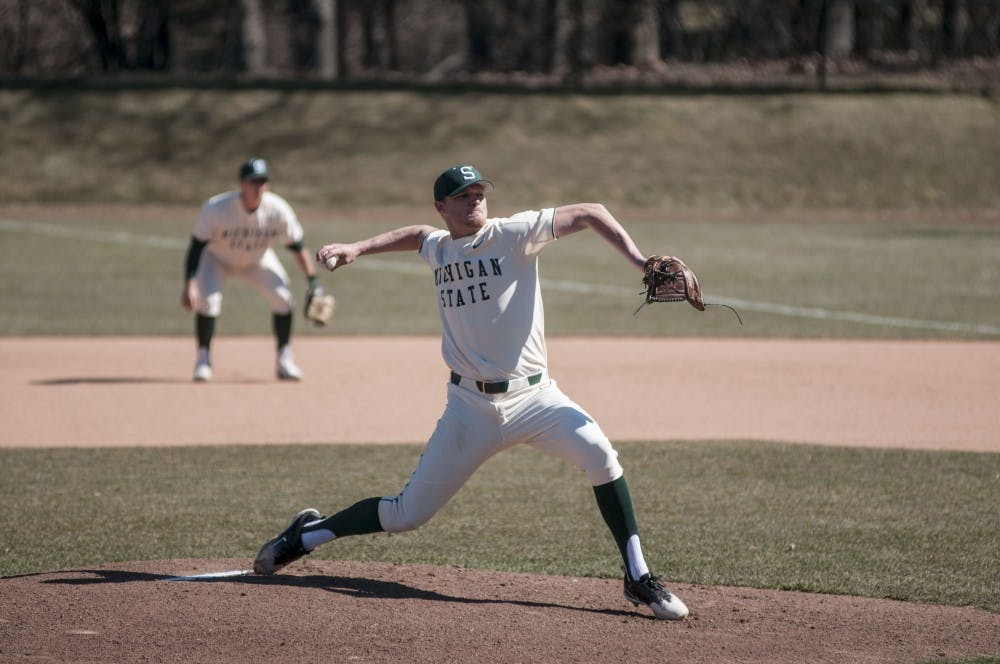 <p>Sophomore pitcher Mike Mokma (20) throws a pitch during the game against Niagara on March 18, 2018 at McLane Baseball Stadium. The Spartans fell to the Purple Eagles, 12-10. (C.J. Weiss | The State News)</p>