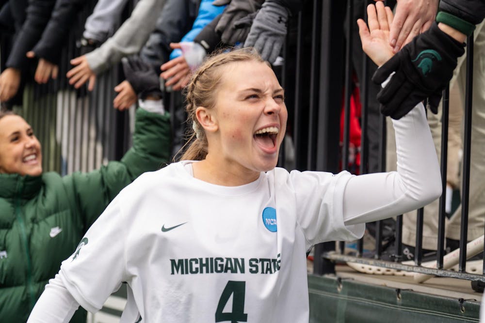 <p>Michigan State University sophomore midfielder Sophia Piotrowski (4) celebrates with fans after the NCAA tournament game against Western Michigan University on Nov. 16, 2024. The Spartans defeated the Broncos, 3-1.</p>