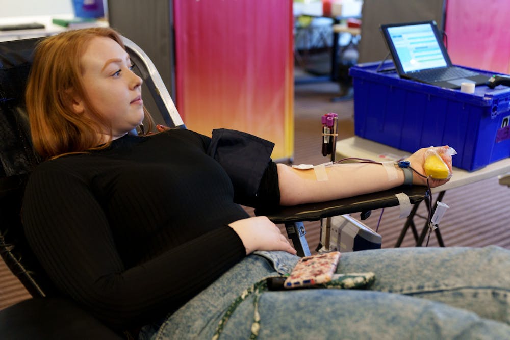 <p>Michigan State interdisciplinary studies sophomore Antoinette Levra is in the process of giving blood during the Blood Drive Showdown sponsored by the MSU UBI chapter in the West Holmes lobby, on April 7, 2022. </p><p>When asked why she was donating today Levra said, &quot;I always donate, but haven&#x27;t had the chance since I haven&#x27;t been home in awhile, so I decided to donate here today.&quot;</p>