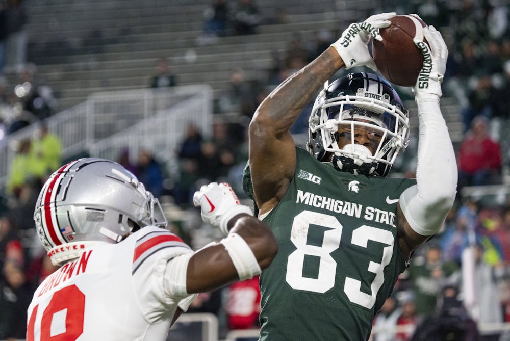 <p>Junior wide receiver Montorie Foster Jr., 83, catches the ball for a Spartan touchdown during Michigan State’s game against Ohio State on Saturday, Oct. 8, 2022 at Spartan Stadium. The Buckeyes ultimately beat the Spartans, 49-20.</p>