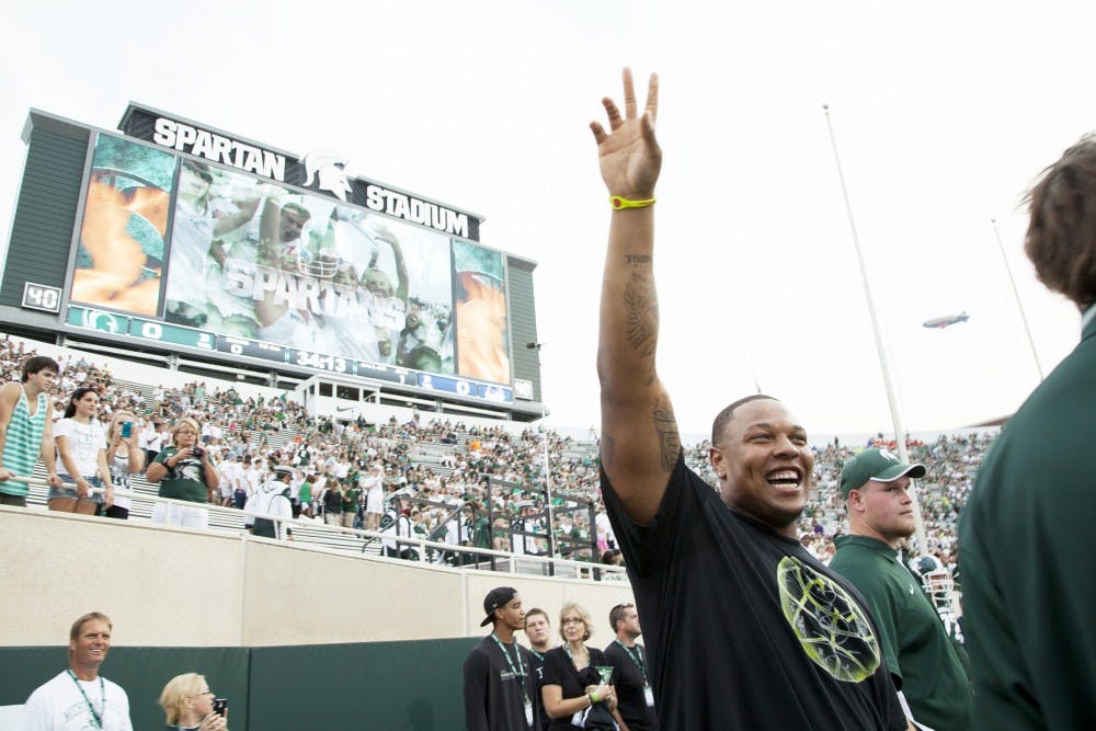 Former MSU football player Jerrel Worthey waves to the crowd Friday night at Spartan Stadium. Following his MSU carrer, Worthey joined the Green Bay Packers. Matt Hallowell/The State News