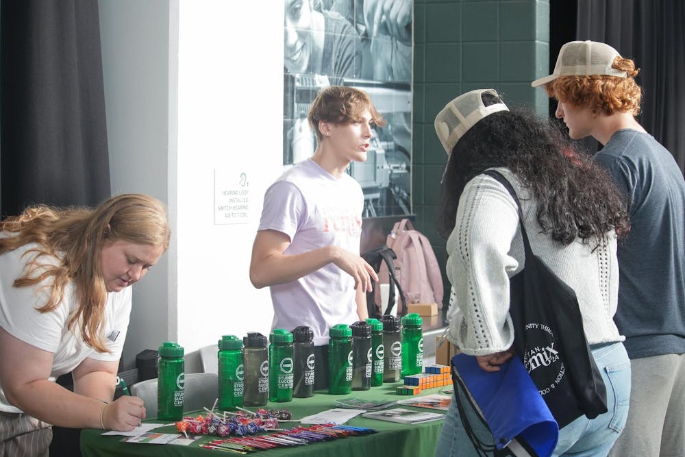 <p>Students talk to members of the Neighborhood Student Success Center while walking around Spartan Remix on Sept. 5th, 2024. Spartan Remix is a student event for multicultural student organizations that helps get their name out to new and prospective students.</p>