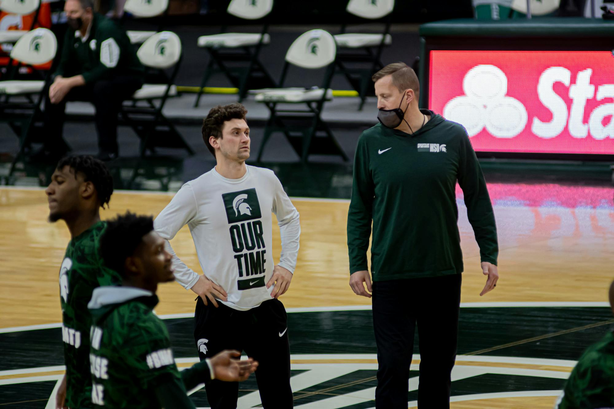 <p>Junior guard Foster Loyer watches the team warm up on Feb. 23, 2021. Loyer was inactive as a player, but helped his team from the bench in the win.</p>